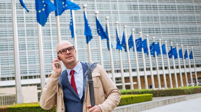 Businessman infront of EU Builing