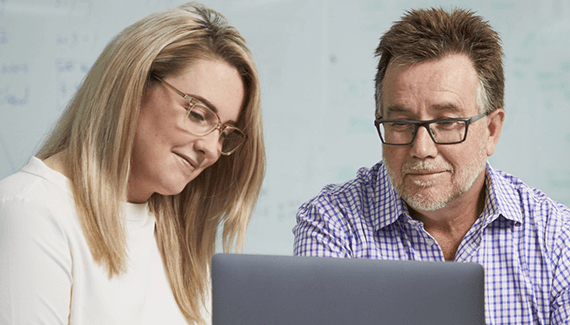 Woman and a man looking at a laptop