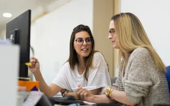 The 10-step guide to building a compelling business case for an HR system ebook cover photo of two women working at a desk
