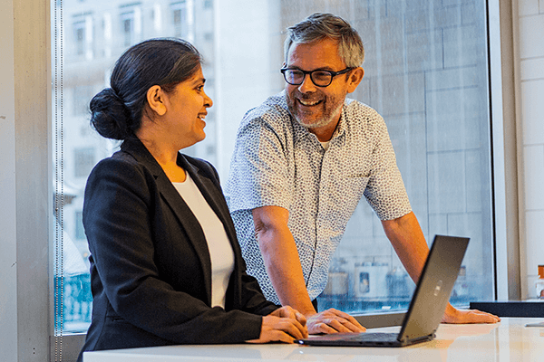 Two people working on laptop