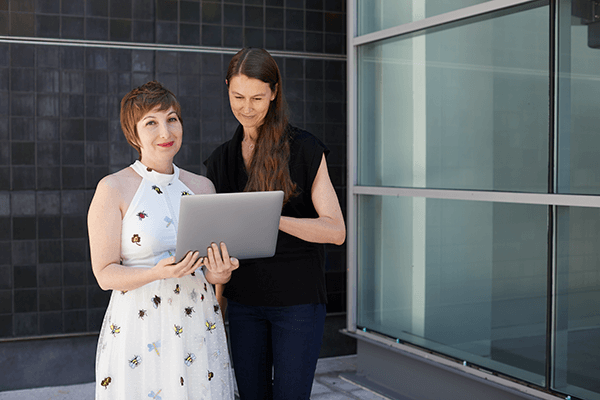Two women working on laptop