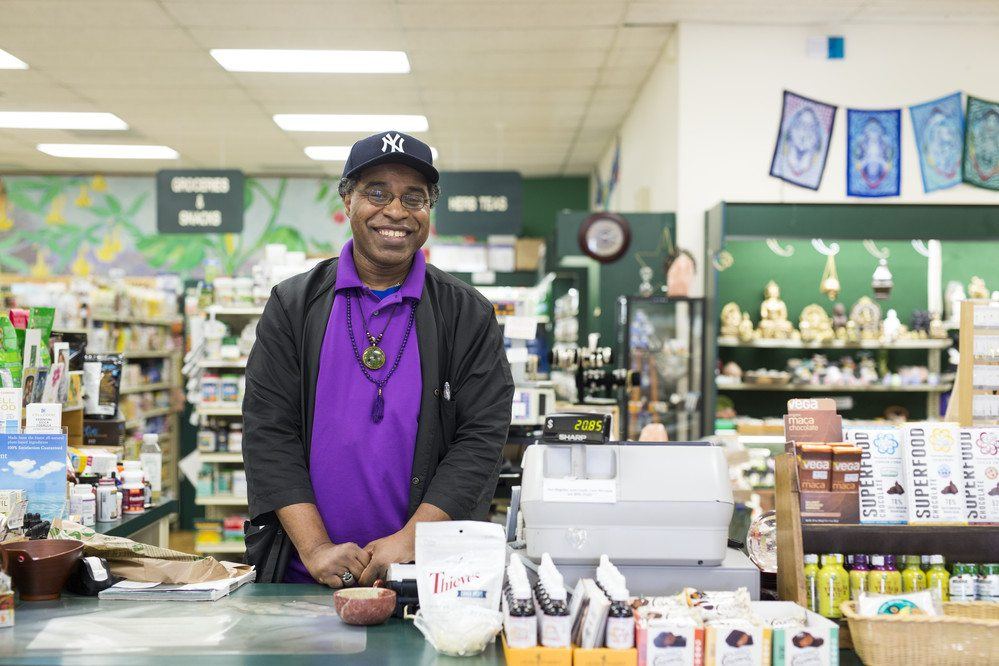 man stands in a grocery store in north america wearing a new york yankees hat