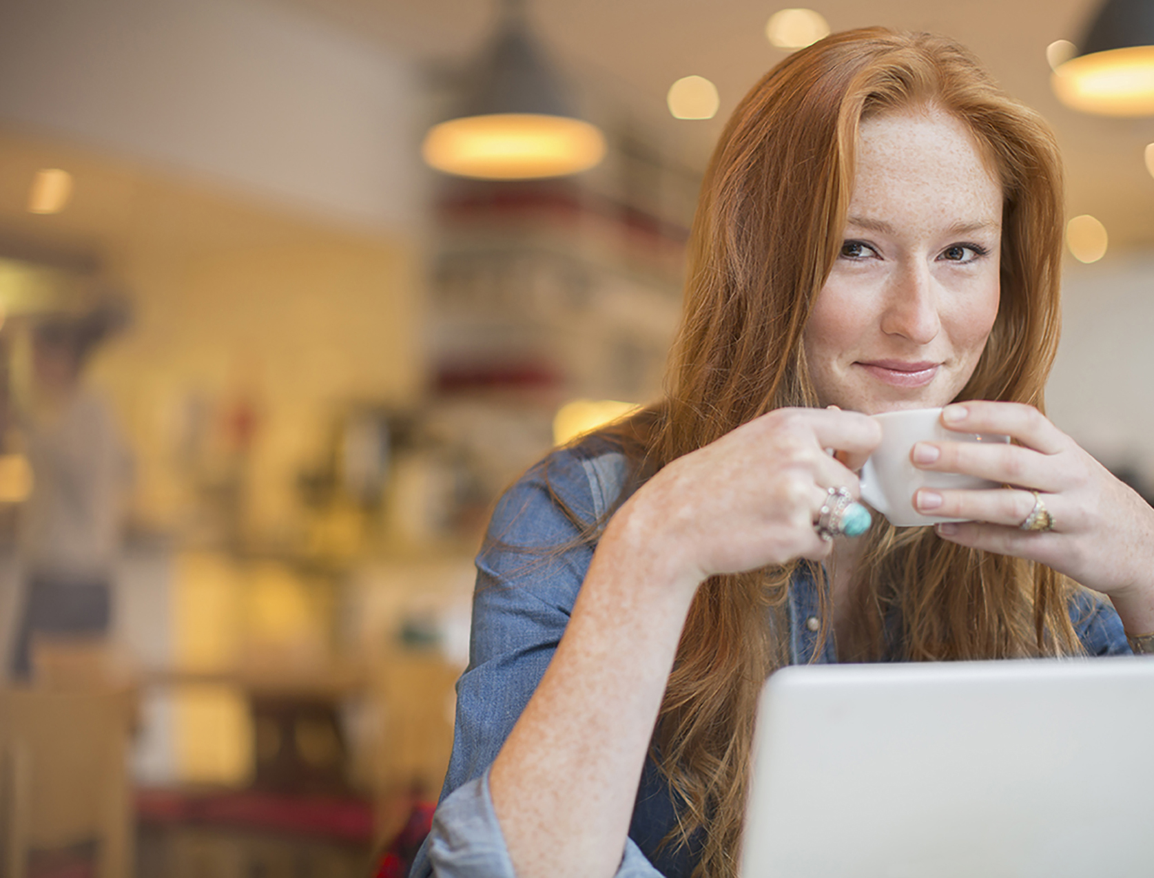 accountant works on laptop drinking coffee
