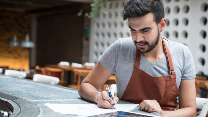 business man doing the books at a restaurant - entrepreneurship concepts