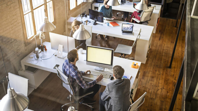 People sitting at desks in a large office