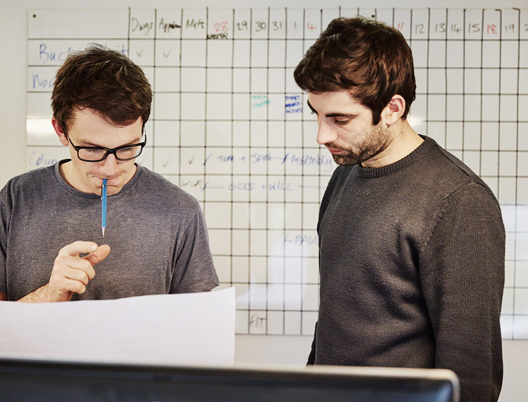 Two men looking at charts