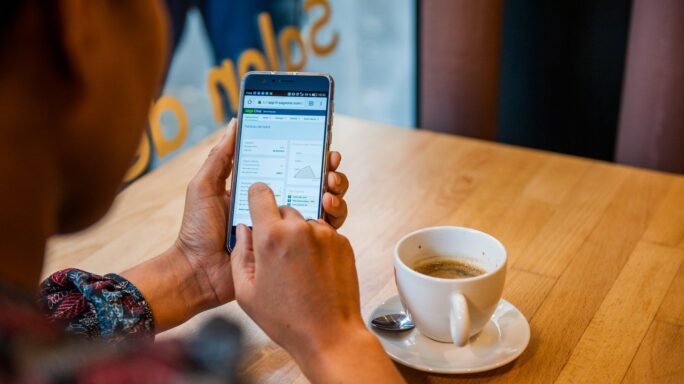 a woman check financial analytics data while enjoying a coffee in a coffee shop