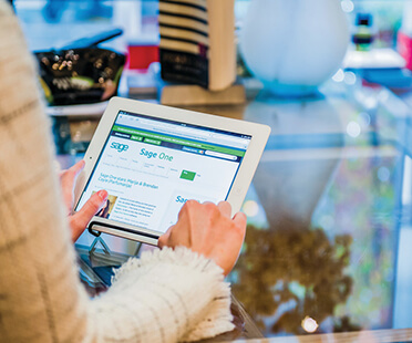 Woman using a tablet at a glass shop counter