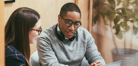 Partners: - business partners panel image: two colleagues sitting looking at a screen