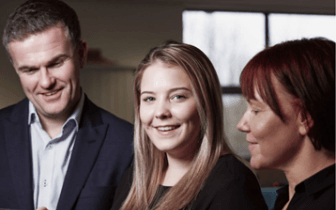 ebook HR automation: 5 ways to raise your game cover photo of woman smiling and working on mobile phone