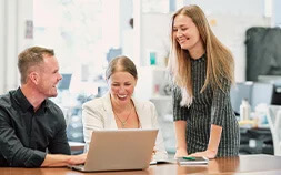 6 ways to create amazing workforce experiences ebook cover of 3 colleagues working on a laptop