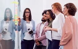 Agility in HR: 4 ways to drive agile ways of working ebook cover photo of 5 colleagues working at whiteboard