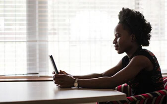 Business resilience and agility: How HR leaders can empower change cover photo of woman working on a tablet at a table