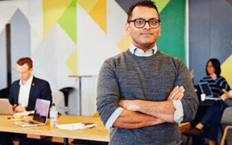 The HR and People leaders' guide to GDPR ebook cover photo of man standing and smiling in open office environment