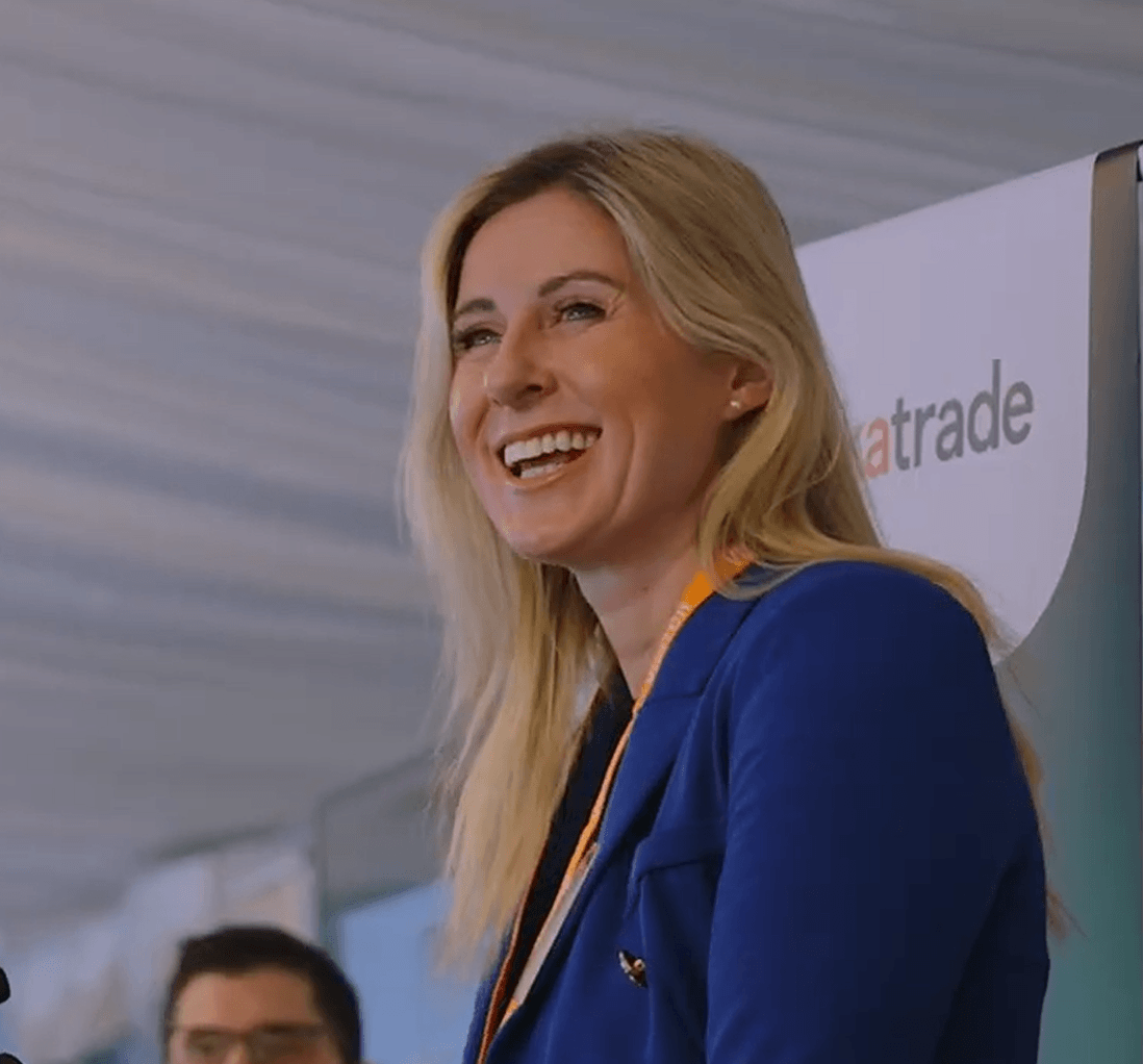 Person smiling whilst talking at an event