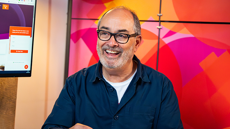 Man laughing while discussing Sage Copilot