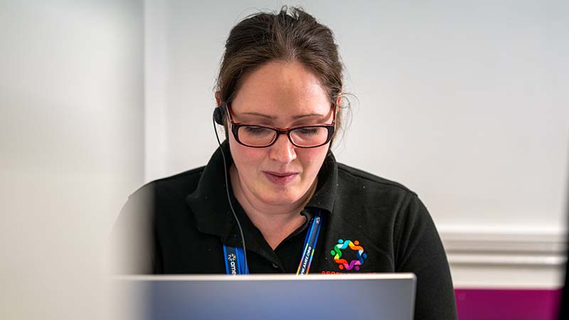 A woman using Sage People's Uptime module