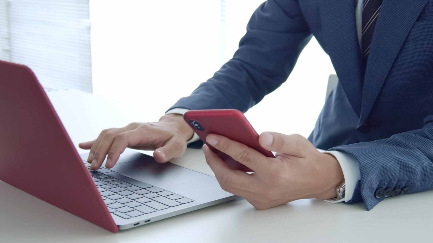 A man entering an MFA code in an office