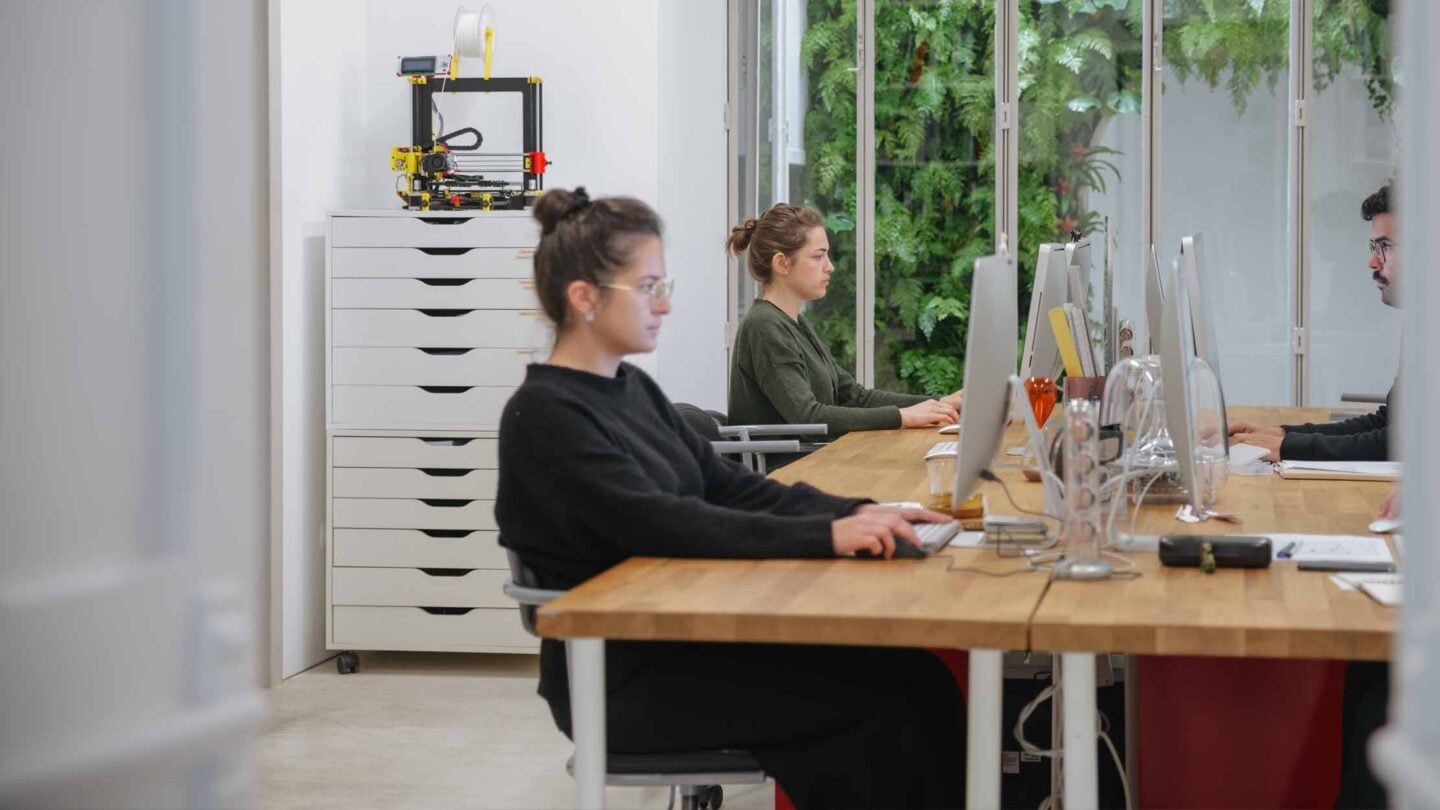 Accountants working in an office observing security within AI