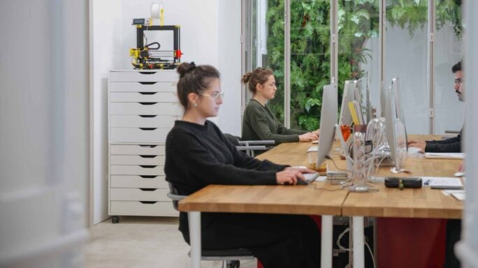 Accountants working in an office observing security within AI
