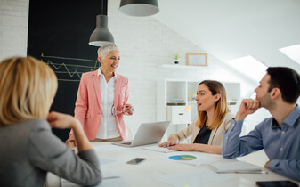 People analytics: 5 vital steps to greater workforce visibility ebook cover photo of woman smiling working at desktop