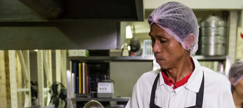 Food worker wearing hairnet.