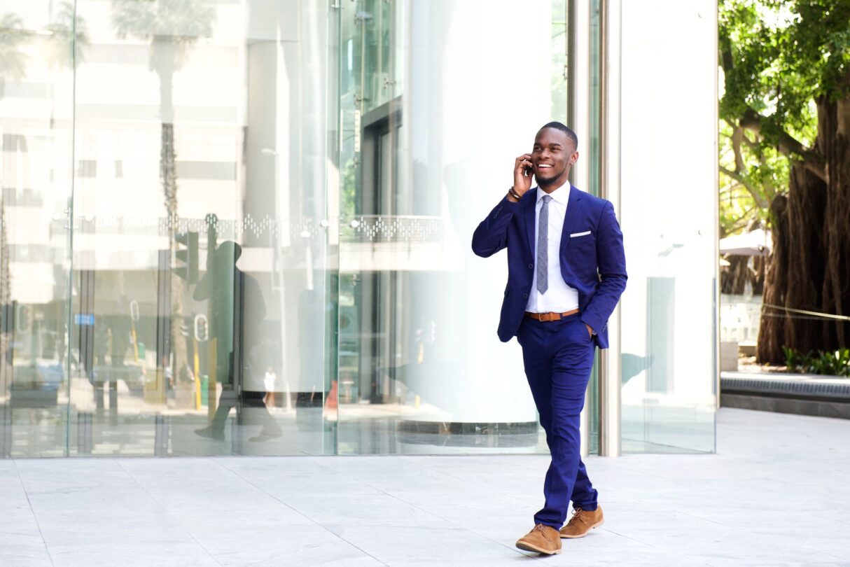 Business man on mobile phone outside office building