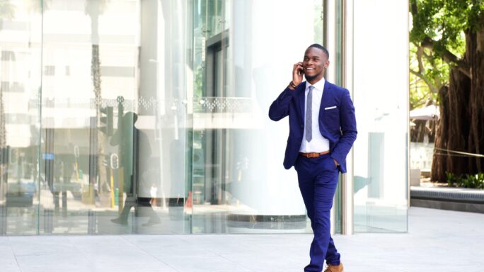 Business man on mobile phone outside office building