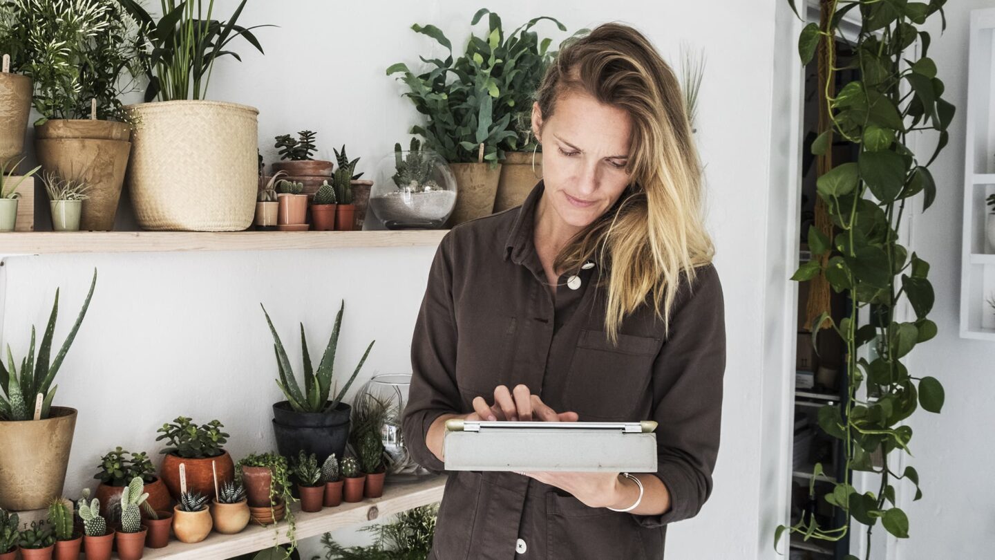 Middle-aged woman operating a tab