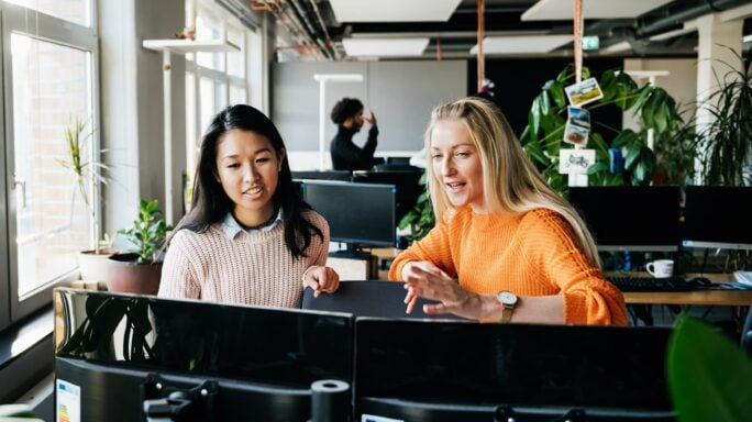 Women discussing in office space