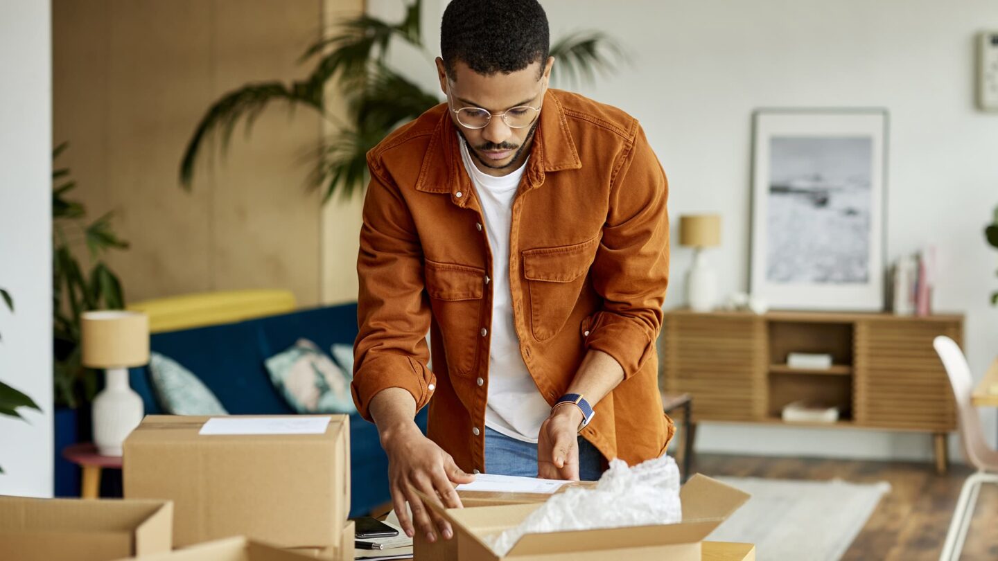 Young man working on delivery boxes