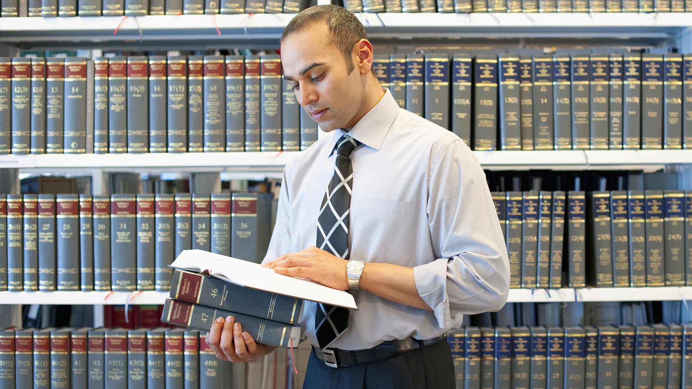 A lawyer going through his book shelf