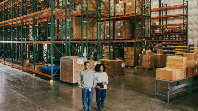 Man and woman in a factory warehouse