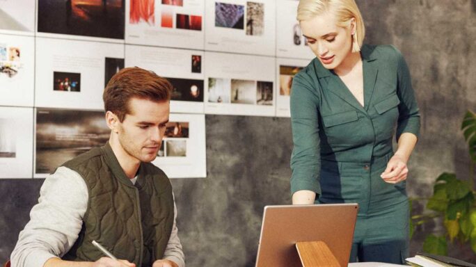 Two people looking at a computer