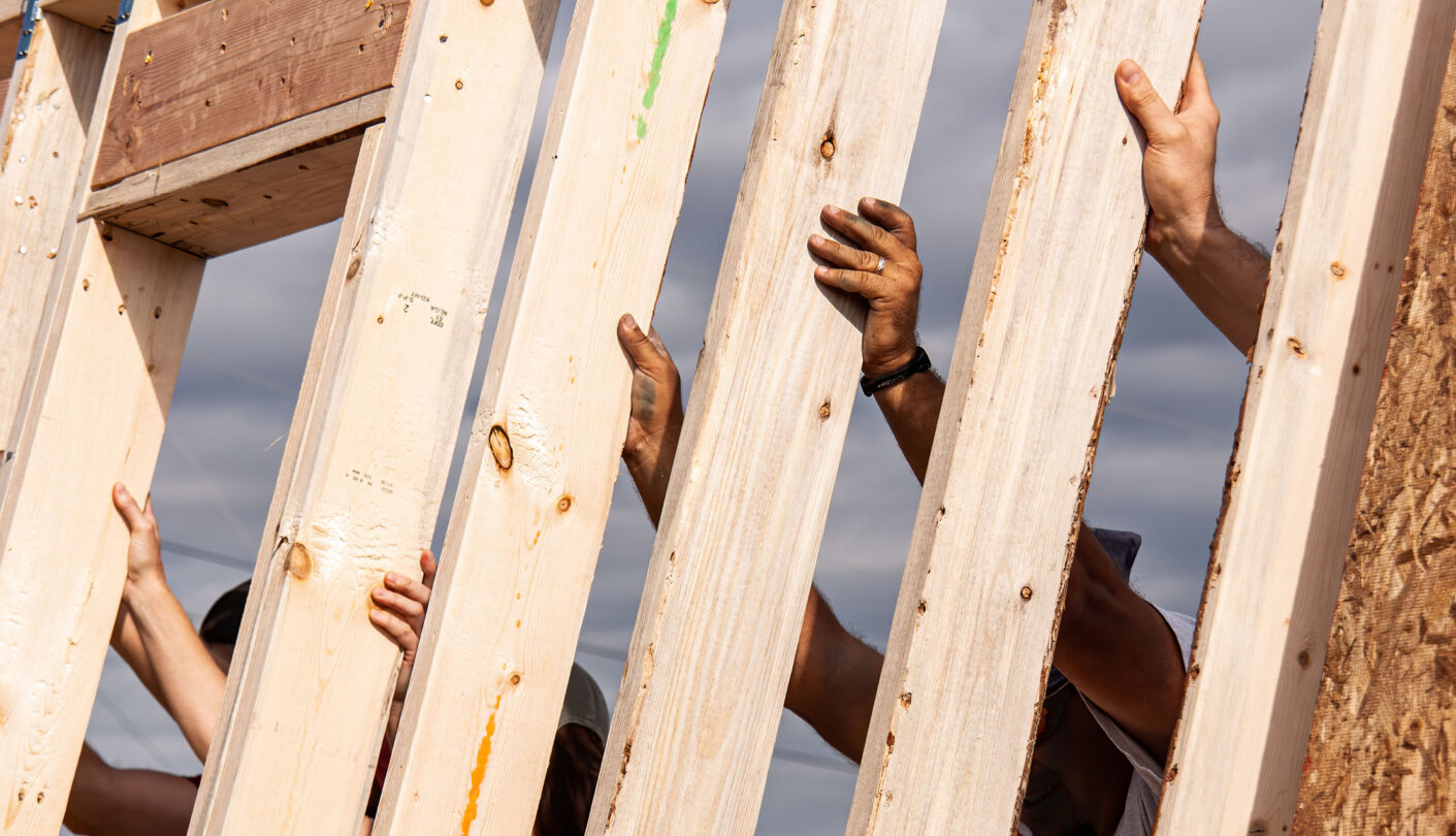 Volunteers framing a house