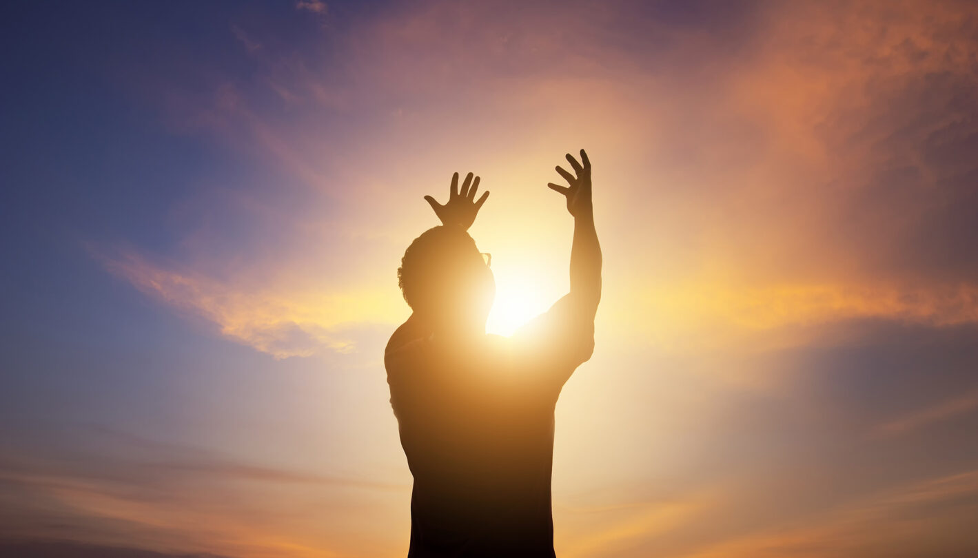 Man of faith raising hands