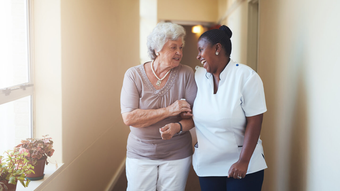 Elderly woman and caregiver