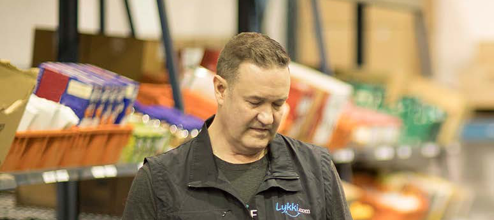 man and woman talking with a laptop between them