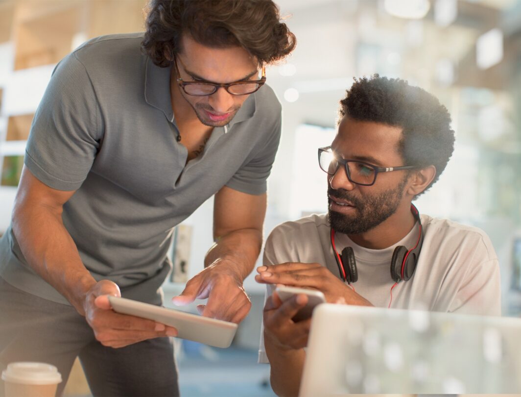 Two men looking at tablet