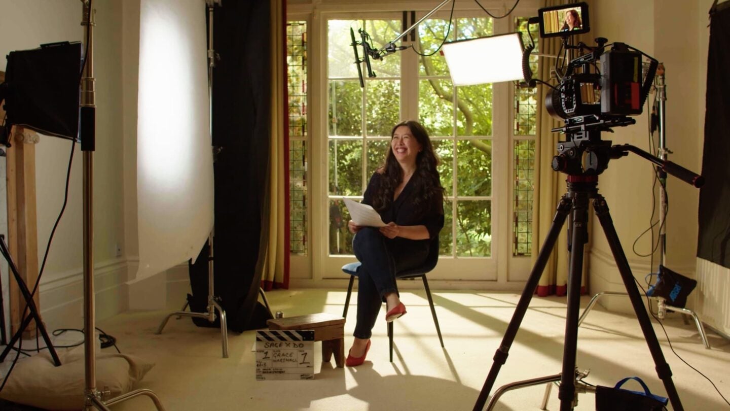 Grace Marshall, seated and being filmed