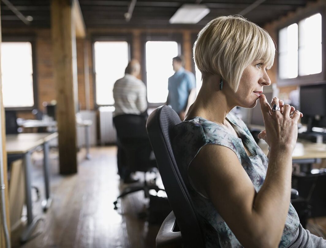 Une femme pensive dans un bureau